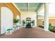 Inviting clubhouse entrance with rocking chairs and decorative plants at 6602 Peach Tree Creek Rd, Bradenton, FL 34203