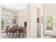 View of the dining room with wallpaper, chandelier and french doors at 6602 Peach Tree Creek Rd, Bradenton, FL 34203