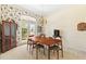 View of the dining room with wallpaper, chandelier and french doors at 6602 Peach Tree Creek Rd, Bradenton, FL 34203