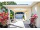 Covered home entrance, with pillars, lush landscaping, and an inviting walkway at 6602 Peach Tree Creek Rd, Bradenton, FL 34203