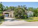 Inviting single-story home with lush landscaping, attached garage, and a well-maintained lawn at 6602 Peach Tree Creek Rd, Bradenton, FL 34203
