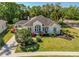 Beautifully landscaped home featuring vibrant landscaping, well-manicured lawn, and inviting front entrance at 6602 Peach Tree Creek Rd, Bradenton, FL 34203