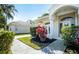 Landscaped front yard featuring colorful plants and an inviting entrance to this charming single-story home at 6602 Peach Tree Creek Rd, Bradenton, FL 34203