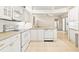 Charming kitchen with white cabinets, tile floors, and stainless steel dishwasher at 6602 Peach Tree Creek Rd, Bradenton, FL 34203