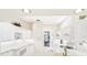 Bright, white kitchen featuring extensive cabinetry, and modern appliances at 6602 Peach Tree Creek Rd, Bradenton, FL 34203