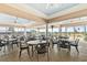 Covered outdoor dining area with ample seating and views of the community and lake at 6602 Peach Tree Creek Rd, Bradenton, FL 34203