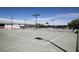 Well-maintained tennis courts with multiple courts, lighting, a fenced perimeter, and a nearby building at 6602 Peach Tree Creek Rd, Bradenton, FL 34203