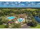 High-angle view of community pools, clubhouse, golf course, and lake, ideal for recreation and relaxation at 7278 Lismore Ct, Lakewood Ranch, FL 34202