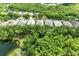 Lovely aerial view of the neighborhood showing the houses' proximity to the lake and trees at 7278 Lismore Ct, Lakewood Ranch, FL 34202