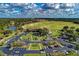 Aerial view of a community showcasing a golf course, lakes, parking, and beautiful single-Gathering homes at 7278 Lismore Ct, Lakewood Ranch, FL 34202