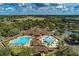 Breathtaking aerial view showcasing a clubhouse, pools, and lush landscaping within a vibrant community at 7278 Lismore Ct, Lakewood Ranch, FL 34202
