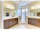 Bathroom featuring dual vanities, mirrors, and a tiled glass shower at 7278 Lismore Ct, Lakewood Ranch, FL 34202
