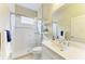 Modern bathroom featuring a glass-enclosed shower, a white vanity with a large mirror, and tile flooring at 7278 Lismore Ct, Lakewood Ranch, FL 34202