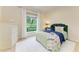 Comfortable bedroom featuring a cozy bed, a bright window, and a neutral color scheme at 7278 Lismore Ct, Lakewood Ranch, FL 34202