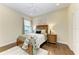 Well-lit bedroom features hardwood floors, a plush area rug, and a window with natural light at 7278 Lismore Ct, Lakewood Ranch, FL 34202