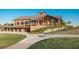 Beautiful clubhouse showcasing architectural details, stone accents, and picturesque landscaping at 7278 Lismore Ct, Lakewood Ranch, FL 34202