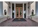 Beautiful clubhouse entrance with stately columns and brick walkway, complemented by elegant light fixtures at 7278 Lismore Ct, Lakewood Ranch, FL 34202
