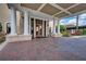 Elegant clubhouse entrance with classic columns, tiled walkway, and beautiful double glass doors at 7278 Lismore Ct, Lakewood Ranch, FL 34202