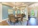 Comfortable dining room showcases a round table, seating for six, and stylish decor with hardwood floors at 7278 Lismore Ct, Lakewood Ranch, FL 34202