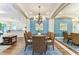 Elegant dining area featuring a round table, stylish chairs, and a full wall mirror creating an inviting ambiance at 7278 Lismore Ct, Lakewood Ranch, FL 34202