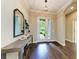 Elegant foyer showcasing hardwood flooring, a stylish console table, and a view of the landscaped front yard at 7278 Lismore Ct, Lakewood Ranch, FL 34202