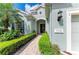 Inviting home exterior featuring a well-manicured lawn, brick pathway, and stylish architectural details at 7278 Lismore Ct, Lakewood Ranch, FL 34202
