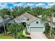Charming single-story home with a two-car garage, lush landscaping, and a welcoming entrance at 7278 Lismore Ct, Lakewood Ranch, FL 34202