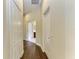 Hallway featuring hardwood floors, natural light, and multiple doorways at 7278 Lismore Ct, Lakewood Ranch, FL 34202