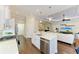 Modern kitchen with stainless appliances, a breakfast bar, and an open layout to the living area at 7278 Lismore Ct, Lakewood Ranch, FL 34202