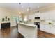 Stylish kitchen with white cabinetry, quartz countertops, and stainless steel appliances at 7278 Lismore Ct, Lakewood Ranch, FL 34202