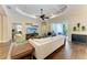 Comfortable living room featuring a tray ceiling, large sofa, and view to outdoor patio at 7278 Lismore Ct, Lakewood Ranch, FL 34202