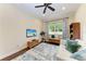 Cozy living room featuring a ceiling fan, area rug, comfortable seating, and a view of the outdoors at 7278 Lismore Ct, Lakewood Ranch, FL 34202