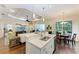 Open-concept living room and eat-in kitchen with coffered ceiling, and dining table at 7278 Lismore Ct, Lakewood Ranch, FL 34202