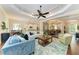 Well-lit living room showcases a neutral color palette, seamlessly connecting kitchen and dining areas at 7278 Lismore Ct, Lakewood Ranch, FL 34202