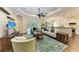 Bright living room with modern decor, a ceiling fan, and sliding doors to the outdoors at 7278 Lismore Ct, Lakewood Ranch, FL 34202