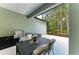 Outdoor kitchen and dining area with a grill, sink, and screened-in view of the green backyard at 7278 Lismore Ct, Lakewood Ranch, FL 34202