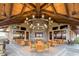 Inviting outdoor seating area with comfortable chairs, tables, and a grand chandelier at 7278 Lismore Ct, Lakewood Ranch, FL 34202