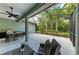 Spacious screened patio with comfortable seating and a grill overlooking the lush backyard at 7278 Lismore Ct, Lakewood Ranch, FL 34202