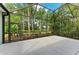The screened patio has an exit door and a lush view of the greenery beyond at 7278 Lismore Ct, Lakewood Ranch, FL 34202
