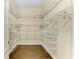 Spacious walk-in closet featuring custom wire shelving and basket storage for optimal organization and accessibility at 7278 Lismore Ct, Lakewood Ranch, FL 34202