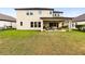 Expansive backyard with a covered patio, outdoor seating area, and well-maintained lawn at 750 116Th Ne Ct, Bradenton, FL 34212