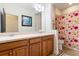 Comfortable bathroom with double vanity, floral shower curtain, and plenty of counter space at 750 116Th Ne Ct, Bradenton, FL 34212