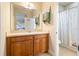 Bathroom featuring a wooden vanity with neutral countertops and a view of the toilet and shower at 750 116Th Ne Ct, Bradenton, FL 34212