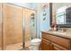 Bathroom features tiled walk-in shower with glass doors and granite topped vanity at 750 116Th Ne Ct, Bradenton, FL 34212