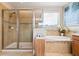 Beautiful bathroom featuring a soaking tub, glass enclosed shower, and decorative tile at 750 116Th Ne Ct, Bradenton, FL 34212