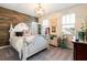 Bedroom featuring decorative headboard, light fixture, and plenty of natural light at 750 116Th Ne Ct, Bradenton, FL 34212