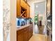 Butler's pantry includes granite counters, wine storage, and blue backsplash with hallway views of the backyard at 750 116Th Ne Ct, Bradenton, FL 34212