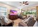 Cozy living room with plush seating, modern ceiling fan, and natural light at 750 116Th Ne Ct, Bradenton, FL 34212