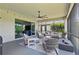 Comfortable screened-in patio with seating and fire pit, perfect for outdoor entertainment at 750 116Th Ne Ct, Bradenton, FL 34212