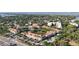 Aerial view of a condo complex surrounded by lush greenery and a view of a lake and water at 850 S Tamiami Trl # 207, Sarasota, FL 34236